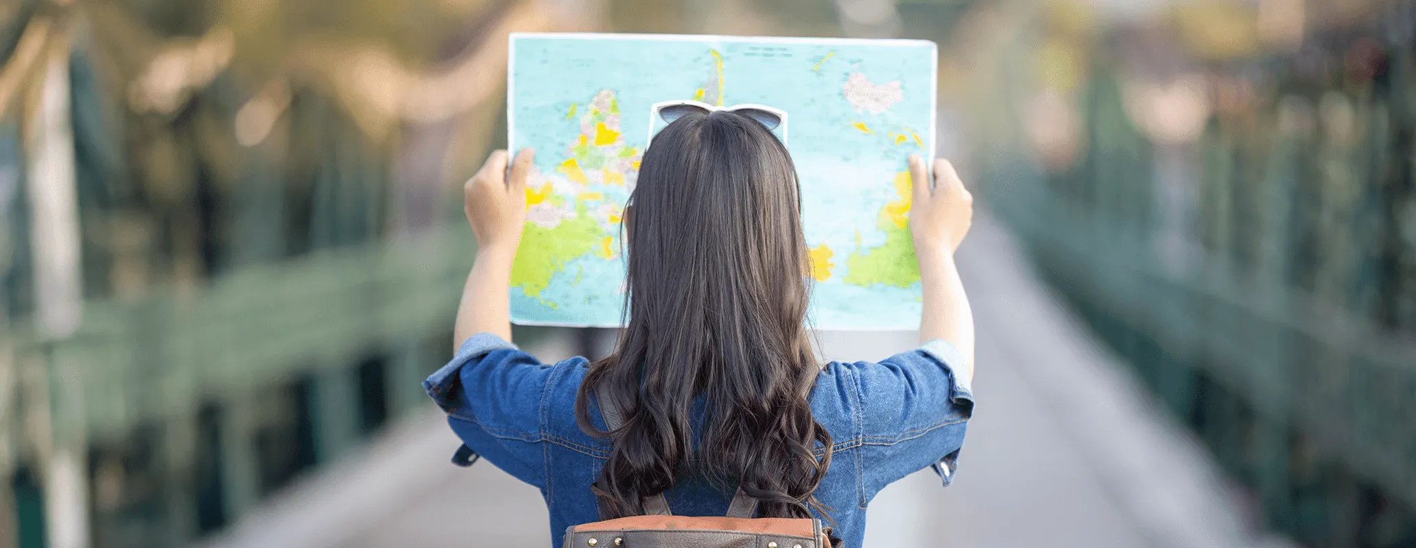 海外の街で地図を見ながら目的地を探す学生（留学生活イメージ）