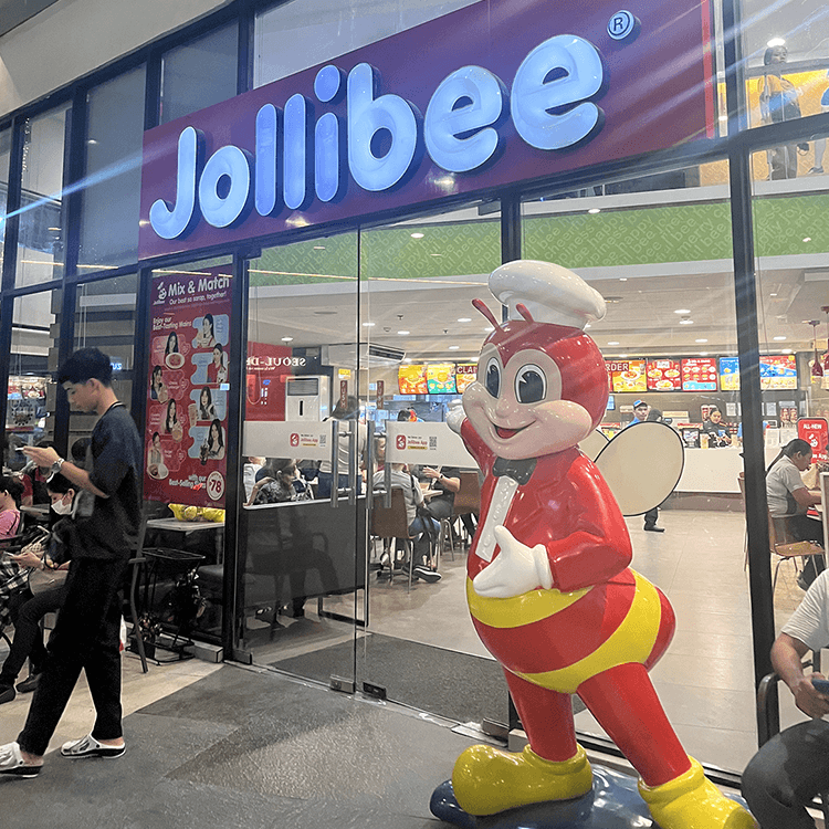 フィリピンのファストフードJollibeeのマスコットと店舗